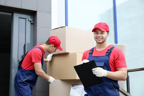 Workers carefully packing IT equipment and documents for an office move