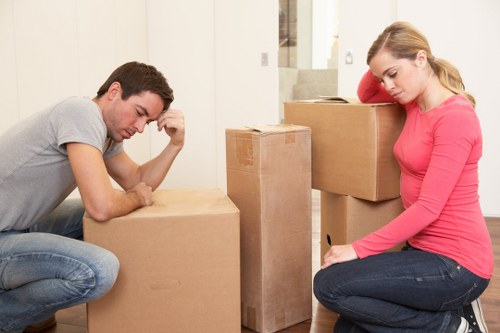 Organised office relocation materials including boxes, labels, and workstation parts